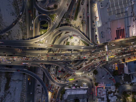 Aerial view of a complex highway interchange at night with flowing traffic illuminated roads and urban infrastructure in Monterrey Nuevo Leon Mexico. Aerial view of a complex highway interchange at night with flowing traffic illuminated roads and urban infrastructure in Monterrey Nuevo Leon Mexico.