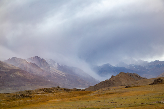 Aerial view of rugged mountains shrouded in mist and dramatic clouds painting a scene of stark beauty Pakistan Aerial view of rugged mountains shrouded in mist and dramatic clouds painting a scene of stark beauty Pakistan