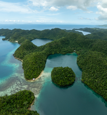 Aerial view of the lush green islands and turquoise lagoons of Bucas Grande featuring dense tropical vegetation and clear coastal waters in Siargao Philippines. Aerial view of the lush green islands and turquoise lagoons of Bucas Grande featuring dense tropical vegetation and clear coastal waters in Siargao Philippines.