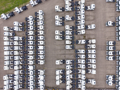 Aerial view of rows of white semi trucks parked in an organized depot at Ekkersrijt 2037 showing the layout of the logistics facility in Son Noord Brabant Netherlands.
