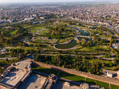 Aerial view of Lahore Fort surrounded by lush gardens historic walls and the sprawling urban landscape of Lahore Punjab Pakistan.