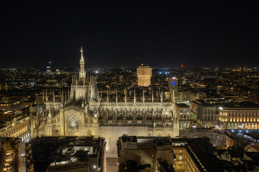 Milan Italy 23 September 2026 Aerial view of the illuminated Duomo di Milano at night showcasing its intricate Gothic spires and the surrounding historic city center rooftops. Milan Italy 23 September 2026 Aerial view of the illuminated Duomo di Milano at night showcasing its intricate Gothic spires and the surrounding historic city center rooftops.