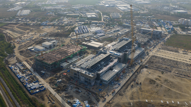 Aerial view of the Bridge Data Center construction site with cranes and industrial buildings under a clear sky in Khlong Tamru Chon Buri Thailand. Aerial view of the Bridge Data Center construction site with cranes and industrial buildings under a clear sky in Khlong Tamru Chon Buri Thailand.