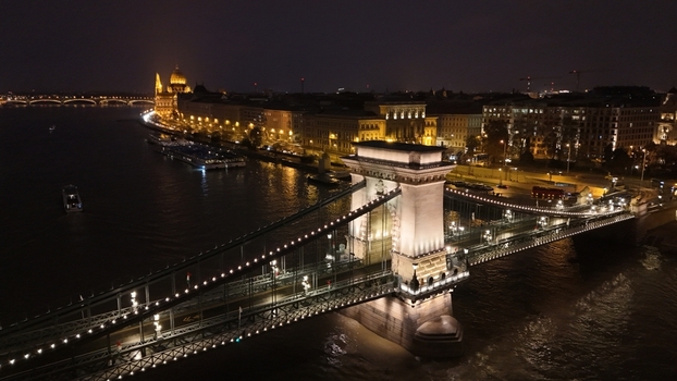 Aerial view of the illuminated Szechenyi Chain Bridge spanning the Danube River at night in Budapest Hungary. Aerial view of the illuminated Szechenyi Chain Bridge spanning the Danube River at night in Budapest Hungary.