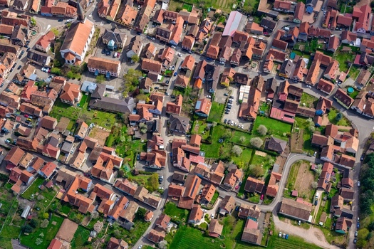 Aerial view of the red tiled rooftops and quaint buildings nestled among patches of green a captivating tapestry of urban and rural life Kintzheim Grand Est France.