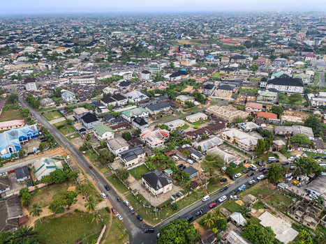 Aerial view of a sprawling urban landscape under an overcast sky showcasing a mosaic of varied rooftops and bustling streets Uyo Akwa Ibom Nigeria. Aerial view of a sprawling urban landscape under an overcast sky showcasing a mosaic of varied rooftops and bustling streets Uyo Akwa Ibom Nigeria.