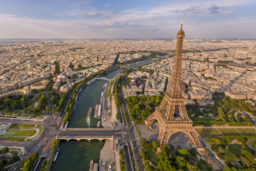 FRANCE. PARIS 75. AERIAL VIEW OF THE EIFFEL TOWER DISPLAYING THE EUROPEAN FLAG STARS WITH THE CHAMP DE MARS AND ECOLE MILITAIRE IN THE BACKGROUND.