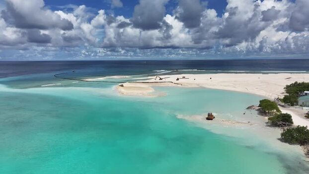 Aerial view of the turquoise lagoon and land reclamation of Gulhi Maldives. Aerial view of the turquoise lagoon and land reclamation of Gulhi Maldives.