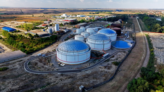 Aerial view of large industrial fuel storage tanks with domed roofs situated in a facility surrounded by fields and roads in Kovin Vojvodina Serbia. Aerial view of large industrial fuel storage tanks with domed roofs situated in a facility surrounded by fields and roads in Kovin Vojvodina Serbia.
