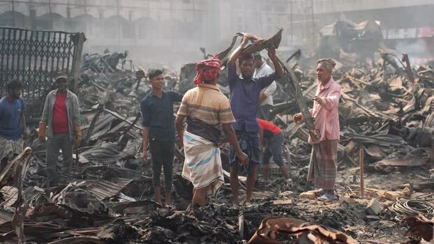 View of people among debris after a fire in Dhaka Bangladesh. View of people among debris after a fire in Dhaka Bangladesh.