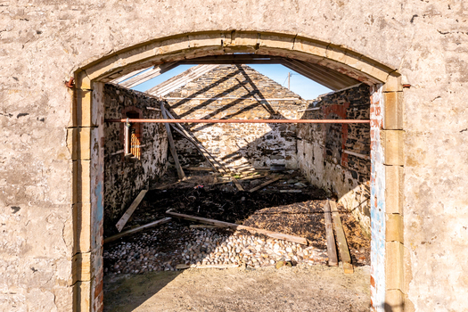 Aerial view of a ruined stone building with an open roof and debris covered floor in Ballyness County Donegal Ireland. Aerial view of a ruined stone building with an open roof and debris covered floor in Ballyness County Donegal Ireland.