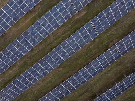 Aerial view of rows of solar panels installed on a green field in Bulgaria. Aerial view of rows of solar panels installed on a green field in Bulgaria.