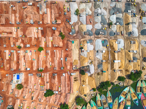 Aerial view of earth and sand quarries with boats lining the shore creating a vibrant contrast of textures and tones Dhaka Dhaka Division Bangladesh. Aerial view of earth and sand quarries with boats lining the shore creating a vibrant contrast of textures and tones Dhaka Dhaka Division Bangladesh.