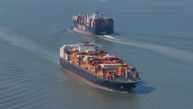 Terneuzen Netherlands 08 April 2026 Aerial view of two large container ships navigating the calm waters of the Western Scheldt under a clear blue sky. Terneuzen Netherlands 08 April 2026 Aerial view of two large container ships navigating the calm waters of the Western Scheldt under a clear blue sky.