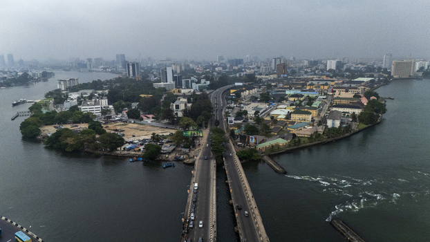 Aerial view of Lagos Island with its dense urban landscape bridges connecting to the mainland and surrounding lagoon waters in Lagos Lagos Nigeria. Aerial view of Lagos Island with its dense urban landscape bridges connecting to the mainland and surrounding lagoon waters in Lagos Lagos Nigeria.