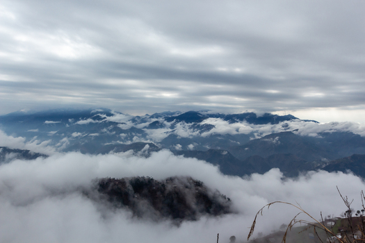 View of dramatic clouds swirl around the rugged mountain peaks creating an ethereal dreamlike landscape Pir Chanasi Azad Kashmir Pakistan. View of dramatic clouds swirl around the rugged mountain peaks creating an ethereal dreamlike landscape Pir Chanasi Azad Kashmir Pakistan.