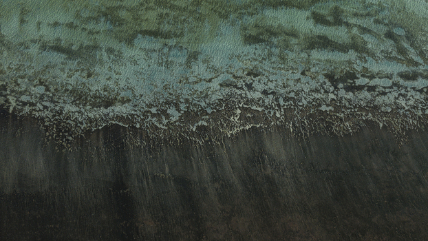 Aerial view of turquoise shallow water meeting dark textured sand patterns along the coastline in Denham Western Australia Australia. Aerial view of turquoise shallow water meeting dark textured sand patterns along the coastline in Denham Western Australia Australia.