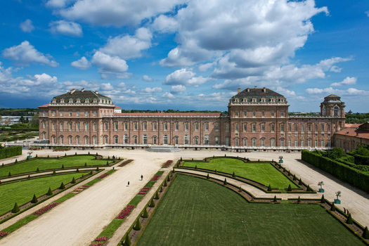 Aerial view of La Venaria Reale palace and its formal gardens with manicured lawns under a blue sky with clouds in Venaria Reale Piemonte Italy. Aerial view of La Venaria Reale palace and its formal gardens with manicured lawns under a blue sky with clouds in Venaria Reale Piemonte Italy.