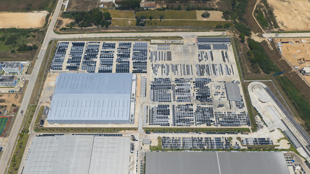 Aerial view of the BYD Thailand Rayong Office Building and expansive parking lots filled with new vehicles at an industrial facility in Phananikhom Rayong Thailand. Aerial view of the BYD Thailand Rayong Office Building and expansive parking lots filled with new vehicles at an industrial facility in Phananikhom Rayong Thailand.