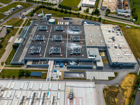 Aerial view of a large industrial facility with flat roofs multiple HVAC units and surrounding parking areas in Zebrak Central Bohemian Region Czechia. Aerial view of a large industrial facility with flat roofs multiple HVAC units and surrounding parking areas in Zebrak Central Bohemian Region Czechia.