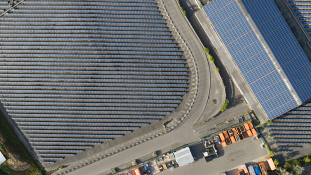 Aerial view of a large solar farm with rows of photovoltaic panels and a building covered in solar arrays in Ludwigshafen Rhineland Palatinate Germany. Aerial view of a large solar farm with rows of photovoltaic panels and a building covered in solar arrays in Ludwigshafen Rhineland Palatinate Germany.