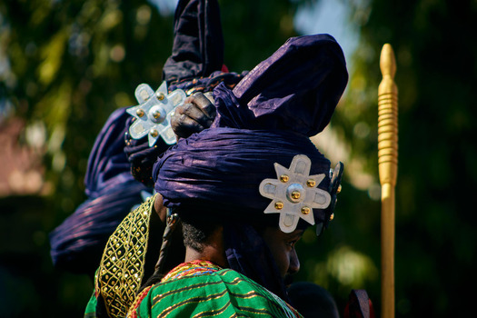 Zaria city Nigeria 21 March 2026 View of a figure in a deep blue turban with gleaming silver stars contrasting vibrant green and gold traditional attire. Zaria city Nigeria 21 March 2026 View of a figure in a deep blue turban with gleaming silver stars contrasting vibrant green and gold traditional attire.