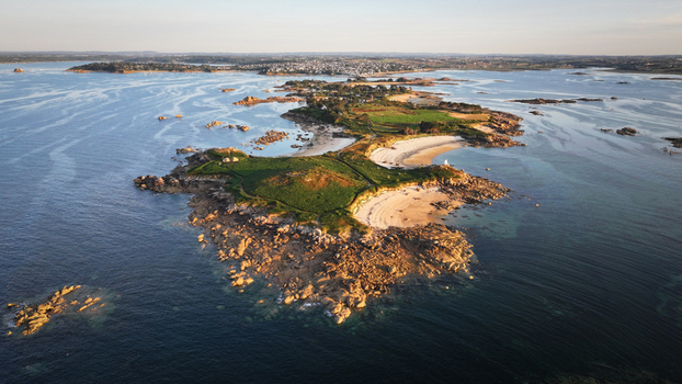 Aerial view of the rugged coastline meets the serene waters rocky outcrops and sandy beaches creating a captivating contrast of textures and tones Carantec Brittany France. Aerial view of the rugged coastline meets the serene waters rocky outcrops and sandy beaches creating a captivating contrast of textures and tones Carantec Brittany France.