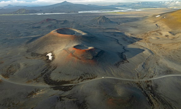 Aerial view of Landmannalaugar volcanic craters with dark lava fields and red tinted rims in Rangarthing ytra Iceland. Aerial view of Landmannalaugar volcanic craters with dark lava fields and red tinted rims in Rangarthing ytra Iceland.