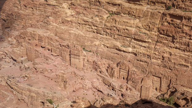 View of the ancient rock cut tombs and facades carved into the sandstone cliffs of the historic site in Wadi Musa Ma an Governorate Jordan. View of the ancient rock cut tombs and facades carved into the sandstone cliffs of the historic site in Wadi Musa Ma an Governorate Jordan.