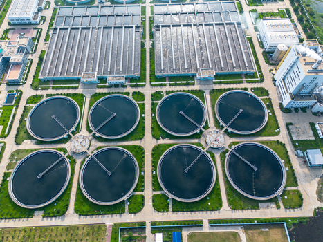 Aerial view of the Sewage Treatment Plant Dhaka WASA featuring circular clarifiers and rectangular tanks surrounded by green spaces in Dhaka Dhaka Division Bangladesh. Aerial view of the Sewage Treatment Plant Dhaka WASA featuring circular clarifiers and rectangular tanks surrounded by green spaces in Dhaka Dhaka Division Bangladesh.