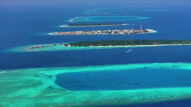 Aerial view of tropical islands and coral reefs in Maldives. Aerial view of tropical islands and coral reefs in Maldives.