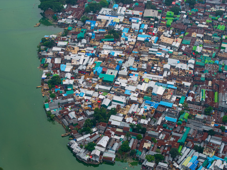 Dhaka Bangladesh 19 June 2026 Aerial view of Gulshan Lake surrounded by dense urban housing with colorful rooftops and narrow streets.