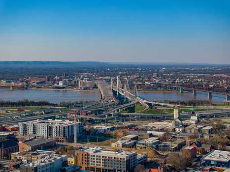 Aerial view of the Abraham Lincoln Bridge and John F. Kennedy Memorial Bridge crossing the Ohio River with the urban skyline and highway interchanges in Louisville Kentucky United States.