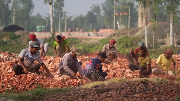 View of workers breaking bricks in Bogura Bangladesh.