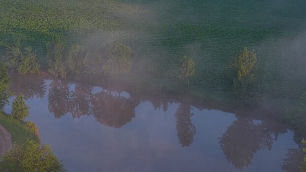 Aerial view of misty fields and a river at dawn France. Aerial view of misty fields and a river at dawn France.