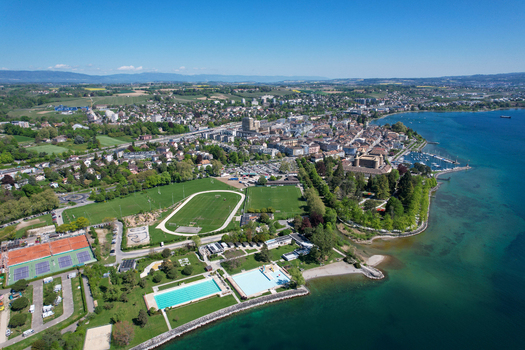 Aerial view of Morges Castle the sports complex and the harbor along the shores of Lake Geneva in Morges Vaud Switzerland. Aerial view of Morges Castle the sports complex and the harbor along the shores of Lake Geneva in Morges Vaud Switzerland.