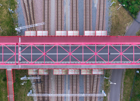 Aerial view of the historic red steel truss viaduct crossing over multiple railway tracks in Gdansk Pomeranian Voivodeship Poland. Aerial view of the historic red steel truss viaduct crossing over multiple railway tracks in Gdansk Pomeranian Voivodeship Poland.