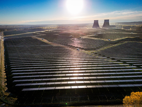 Trino Italy 30 March 2026 Aerial view of solar panels reflecting sunlight stretching towards the distant cooling towers under a clear sky. Trino Italy 30 March 2026 Aerial view of solar panels reflecting sunlight stretching towards the distant cooling towers under a clear sky.