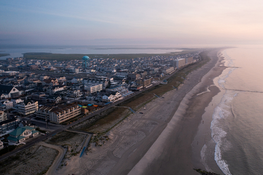 Aerial view of Sea Isle City Beach at sunrise featuring the coastline residential buildings and a water tower in Sea Isle City New Jersey United States.