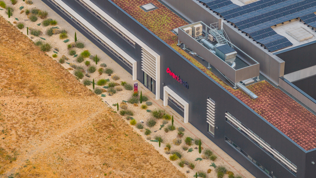 Alixan France 25 July 2026 Aerial view of Aventech headquarters featuring a green roof rooftop HVAC systems and solar panels surrounded by dry landscaping.