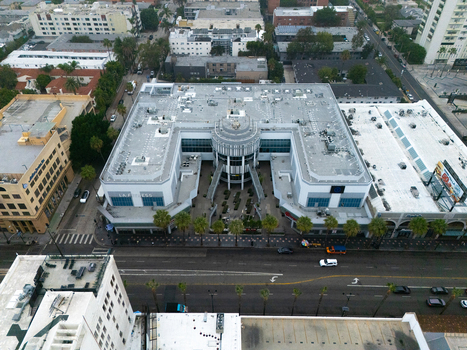Los Angeles United States 25 September 2026 Aerial view of the Hollywood Walk of Fame featuring a modern commercial building palm trees and surrounding urban streets.