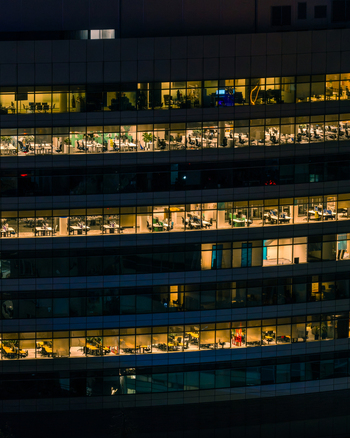 Aerial view of modern business center with illuminated office windows at night in Warsaw Masovian Voivodeship Poland.