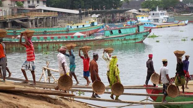 View of workers carrying sand baskets at Aminbazar port Bangladesh.
