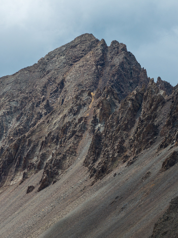 Aerial view of the rugged peak of Mount Sneffels in the San Juan Mountain Range featuring steep rocky slopes and jagged ridges in Ouray Colorado United States. Aerial view of the rugged peak of Mount Sneffels in the San Juan Mountain Range featuring steep rocky slopes and jagged ridges in Ouray Colorado United States.
