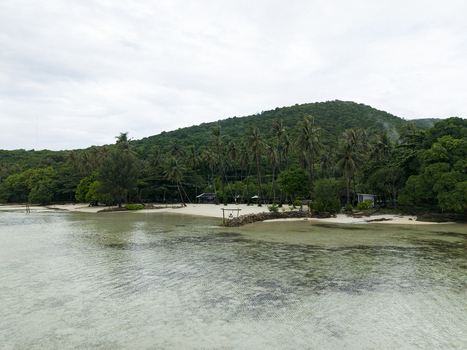Aerial view of the serene Bobby Beach with its pristine white sands meeting the clear turquoise waters under a soft overcast sky Karimunjawa Jawa Tengah Indonesia.