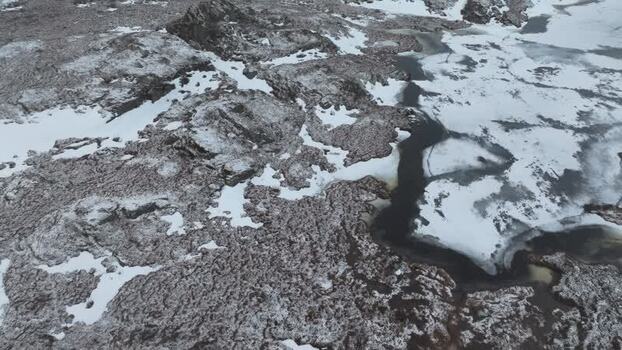 Aerial view of snowy rocky terrain in Lofoten Norway.