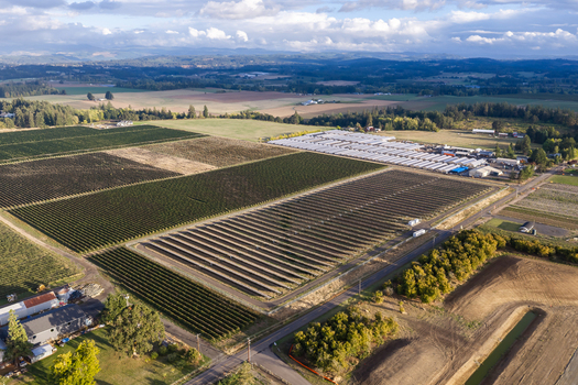 Aerial view of rural farmland with rows of crops greenhouses and solar panels in Woodburn Oregon United States. Aerial view of rural farmland with rows of crops greenhouses and solar panels in Woodburn Oregon United States.