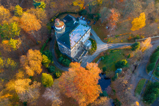 Aerial view of Zamecky park Vratislavice Nad Nisou featuring a historic building with solar panels surrounded by vibrant autumn trees and a small pond in Liberec 30 Liberec Region Czechia. Aerial view of Zamecky park Vratislavice Nad Nisou featuring a historic building with solar panels surrounded by vibrant autumn trees and a small pond in Liberec 30 Liberec Region Czechia.