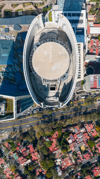 Mexico City Mexico 15 July 2026 Aerial view of Torre Mitikah the tallest skyscraper in CDMX with a distinctive oval shaped roof surrounded by urban streets and residential buildings. Mexico City Mexico 15 July 2026 Aerial view of Torre Mitikah the tallest skyscraper in CDMX with a distinctive oval shaped roof surrounded by urban streets and residential buildings.