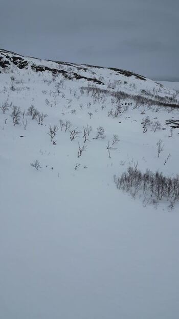 Aerial view of snowy mountain slopes on Kvaloya island Norway.